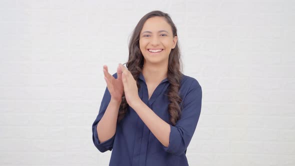 Happy Indian girl clapping