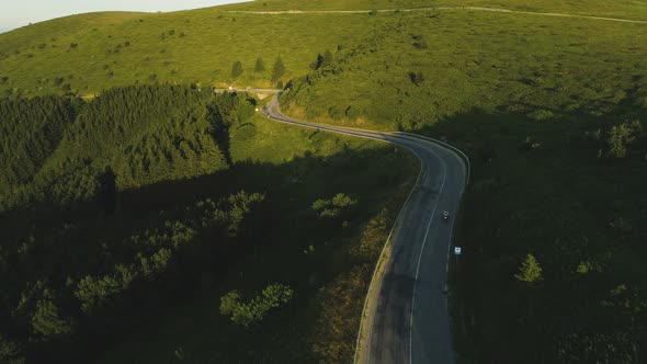 Drone Follows Biker Going Fast Down the Mountain Road