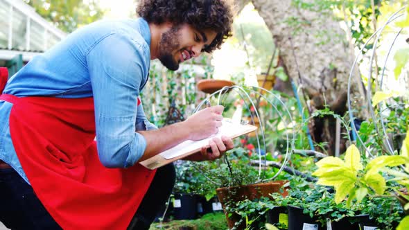 Gardener taking notes of plants