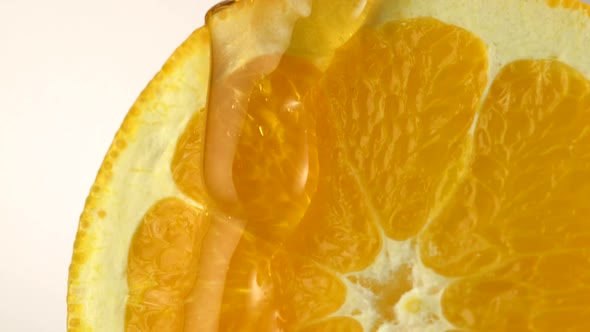 Honey pouring on orange, Slow Motion