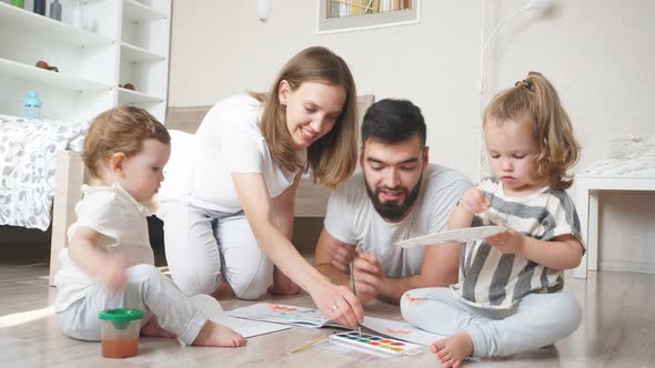 Young Parents Developing Their Kid's Painting Skills