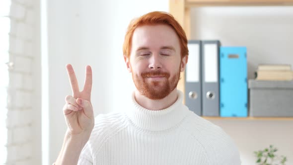 Victory Sign by Handsome Man with Red Hairs