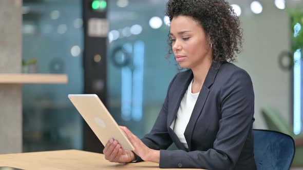 African Businesswoman Using Tablet at Work