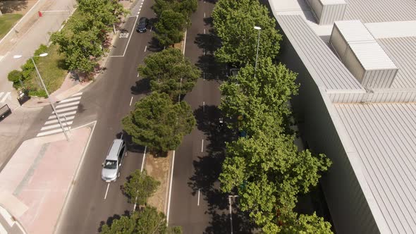 Lonely bicycle riding on almost empty street of Madrid, aerial drone follow