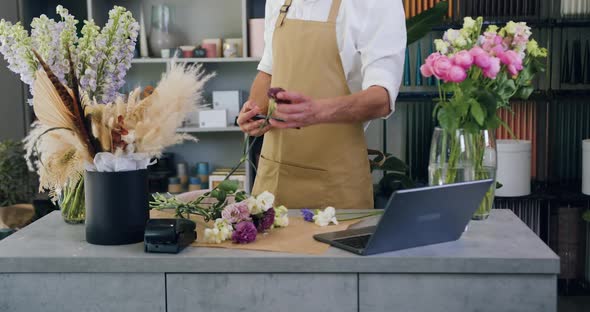 Man Florist Holding Potted Flower and Taking Photo on Smartphone for Advertising on Social media