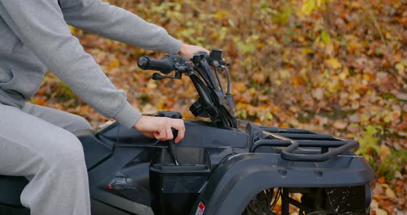 Closeup View of a Guy in a Gray Opposite Suit Riding an ATV