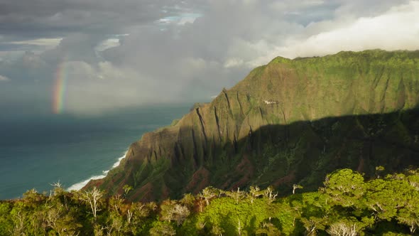 Grassy Rocks of Mountainous Coastal Terrain of Hawaii Illuminated By Sunset Light. Aerial Shot