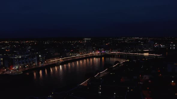 Aerial Panoramic View of Illuminated Bridge and Waterfront in City