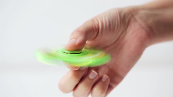 Hand Playing with Spinning Fidget Spinner 