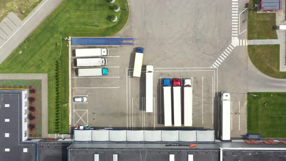 Aerial view. goods distribution warehouse. Semi trucks loading cargo containers. Logistics export an