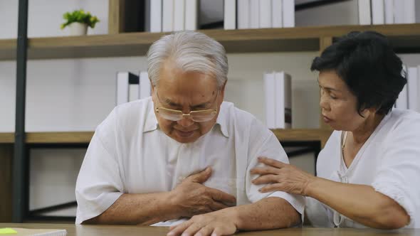 Health concept. Asian senior man suffering from chest pain and heart attack at home. 4k Resolution