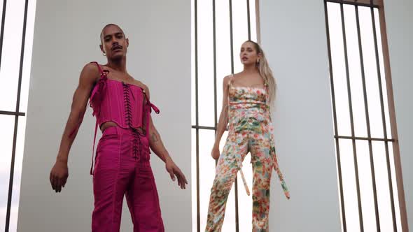 Dancers Posing and Moving in Clubwear By Barred Windows