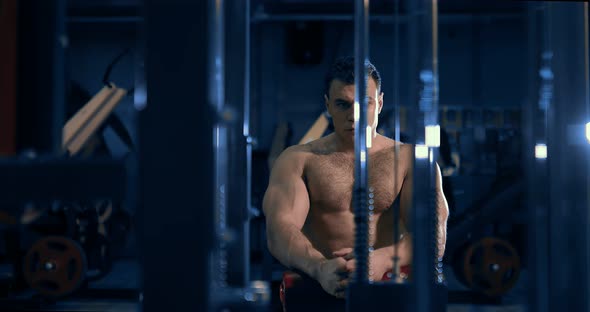 Bodybuilder Resting Near the Gym in the Gym