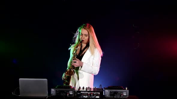 Young Sexy, Blonde Woman Dj Playing Music Using Saxophone on Black