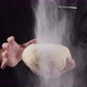 Flour is Poured Onto a Lump of Dough in the Hand of a Chef - VideoHive Item for Sale