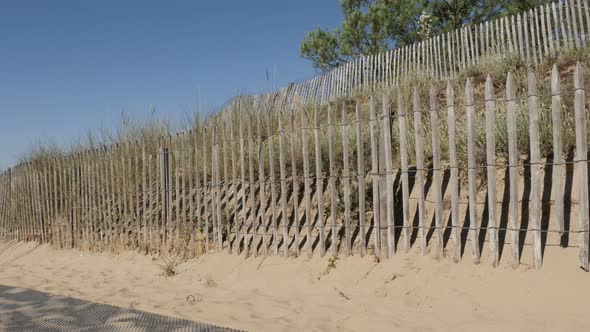 Planks in a row leading to sea beach slow tilt 4K 3840X2160 UltraHD footage - Old wooden fence and p