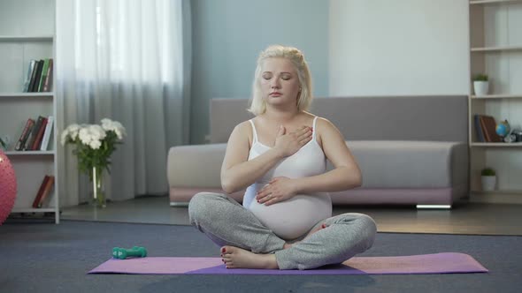 Calm Pregnant Woman Listening to Sensations and Touches of Baby in Her Belly