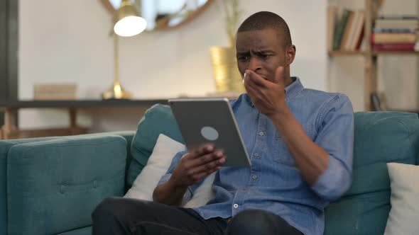 Loss, Young African Man Reacting To Failure on Sofa 