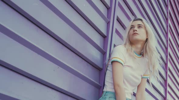 Woman grunge standing at a colorful wall