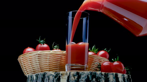 Pour Natural Tomato Juice Into A Glass On A Black Background. Fresh Tomatoes With Tomato Juice