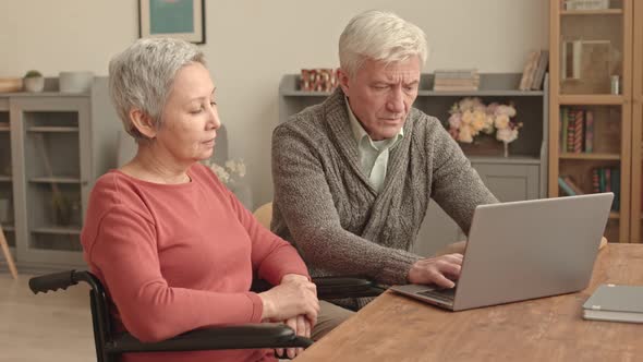 Man Typing on Computer for Wife