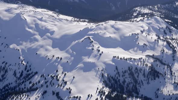 Snowcovered Whistler Mountains On A Sunny Winter Day In Whistler, British Columbia, Canada. aerial