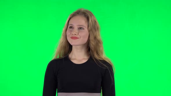 Blonde Girl Daydreaming and Smiling Looking Up. Green Screen