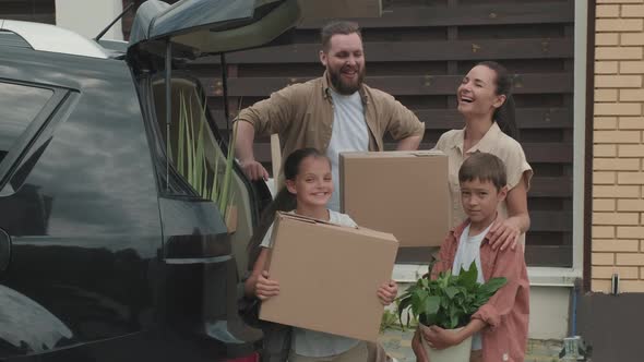 Portrait of Family of Four Moving House