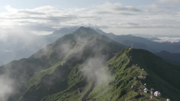 Aerial View Mountain Ridge Panorama Flight Through the Clouds at Sunrise