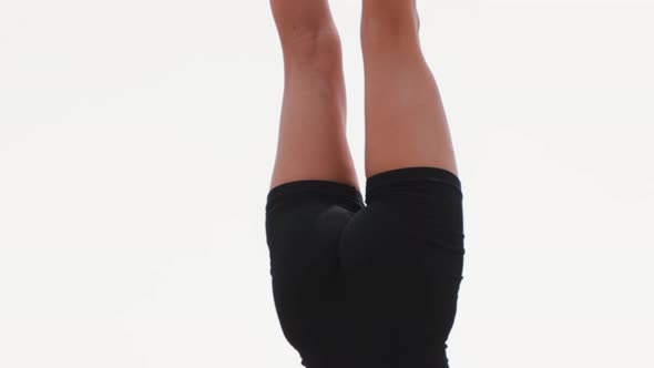 Young Blonde Woman Doing Gymnastics Handstand on the Coasters