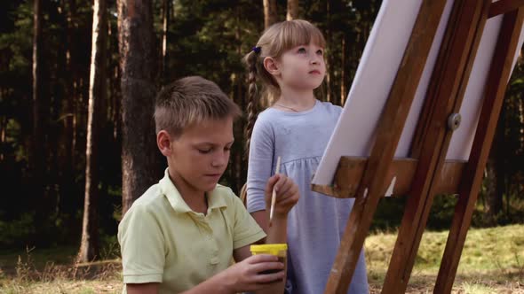 Happy Family Boy and Girl Drawing Coloring Picture with Brush Helping Cute Child Daughter Enjoying