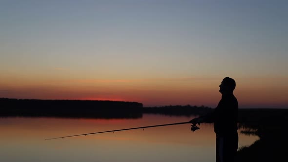 A Man Fishing  Throws the Fishing Rod