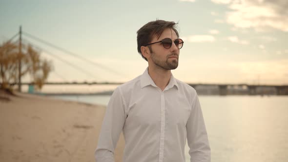 Man Walking On Sand Beach. Businessmen In Pants Stroll On City Sands Beach. Guy Walks On Sand.