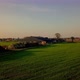 Aerial Cinematic Clip Drone Flying Over a Farm Field During Sunset - VideoHive Item for Sale
