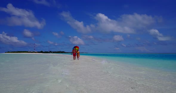 Beautiful lady and man on honeymoon vacation live the dream on beach on white sand background 