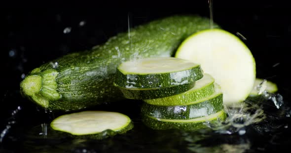 Whole and Round Slices of Zucchini with Drops of Water. 