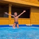 the boy is playing in the home pool - VideoHive Item for Sale