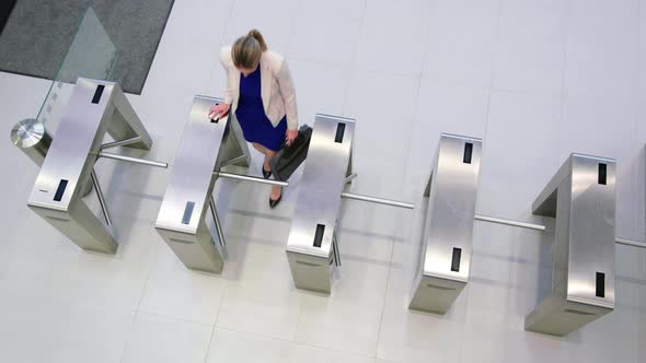 Businesswomen scanning their cards at turnstile gate