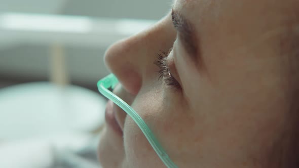 Woman with Nasal Cannula Getting Hospital Treatment