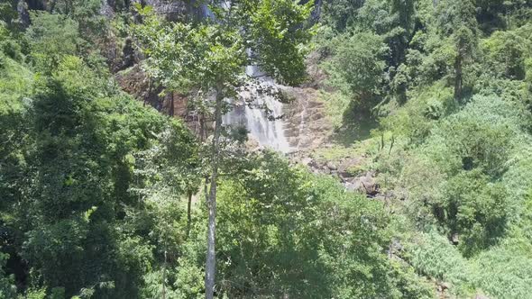 Diyaluma Falls with Cascades on High Steep Cliff in Forest