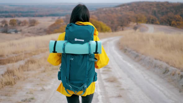 Woman Traveler with Backpack Exploring on Top of Mountains