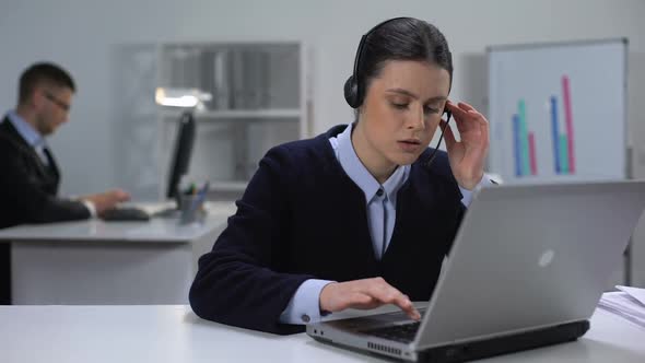 Call Center Manager in Headset Checking Data on Laptop, Customer Support