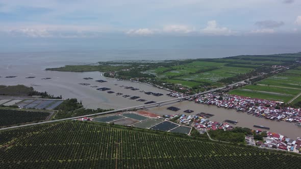 Aerial view Kuala Kurau fishing village near oil palm farm