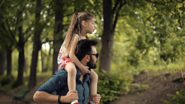 Happy Family Father Day Child Girl Leisure. Daughter Sitting On Father Neck. Little Kid Having Fun.