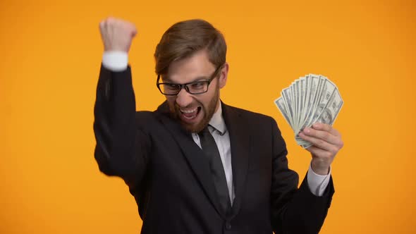 Business Man Showing Dollar Banknotes and Doing Yes Gesture, High Salary, Income