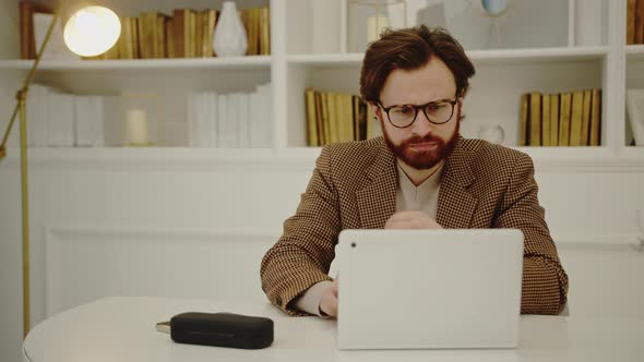 European Millennial Male Entrepreneur Sitting in His Home Office