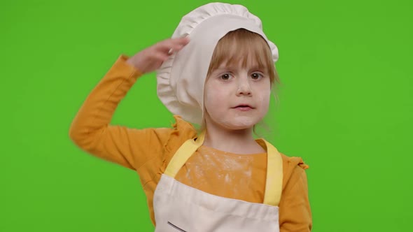 Funny Child Girl Kid Dressed Cook Chef Baker in Apron and Hat Dancing Fooling Around Making Faces