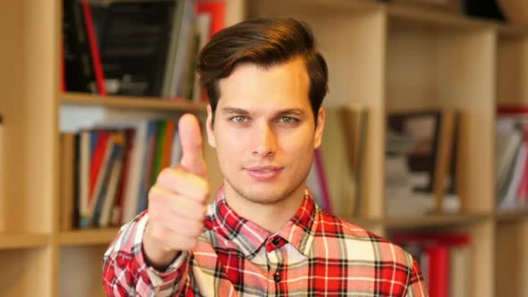 Thumbs Up Sign by Successful Young Man Indoor