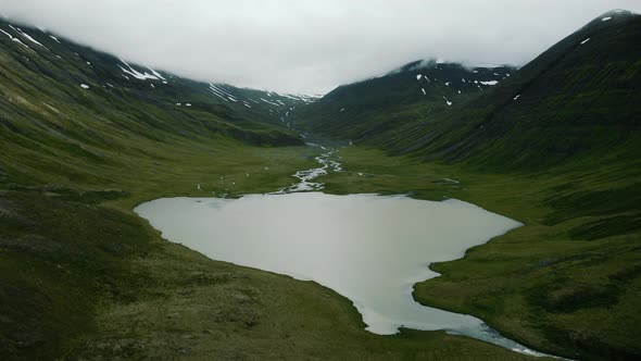 Aerial View of Nordic Landscape Flyover Green Valley Beautiful Formations and Mountains Covered with