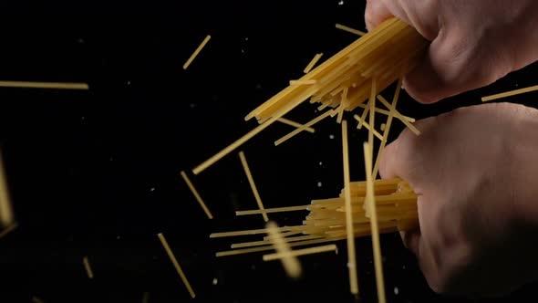 Hands Breaking a Bunch of Spaghetti